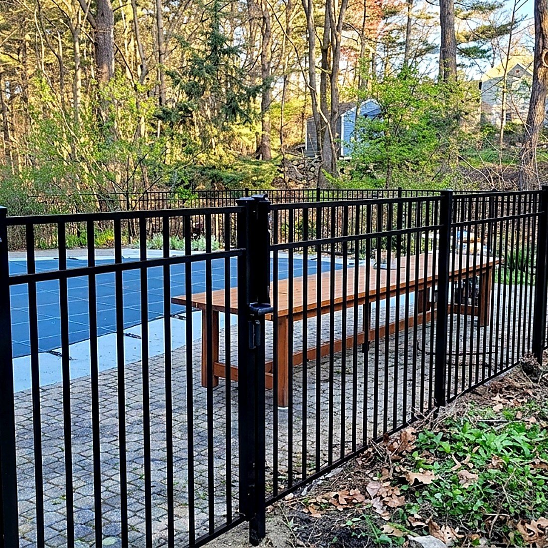 Black aluminum fence around a pool deck