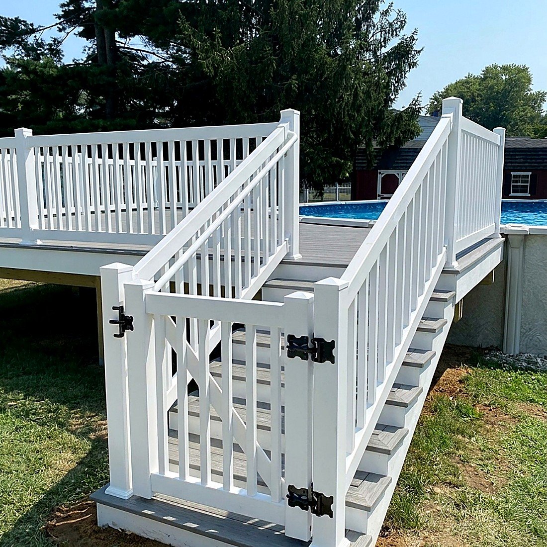 White PVC deck railing with stairs to pool